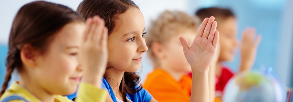 Children raising hands knowing the answer to the question