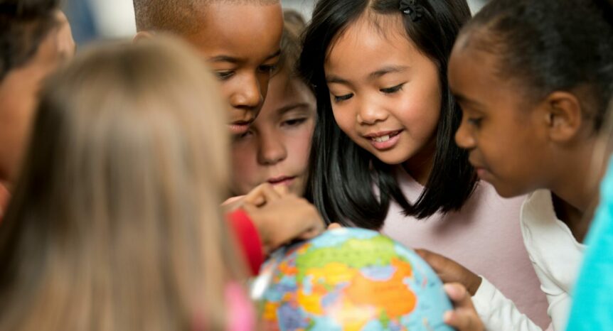 kids exploring globe model