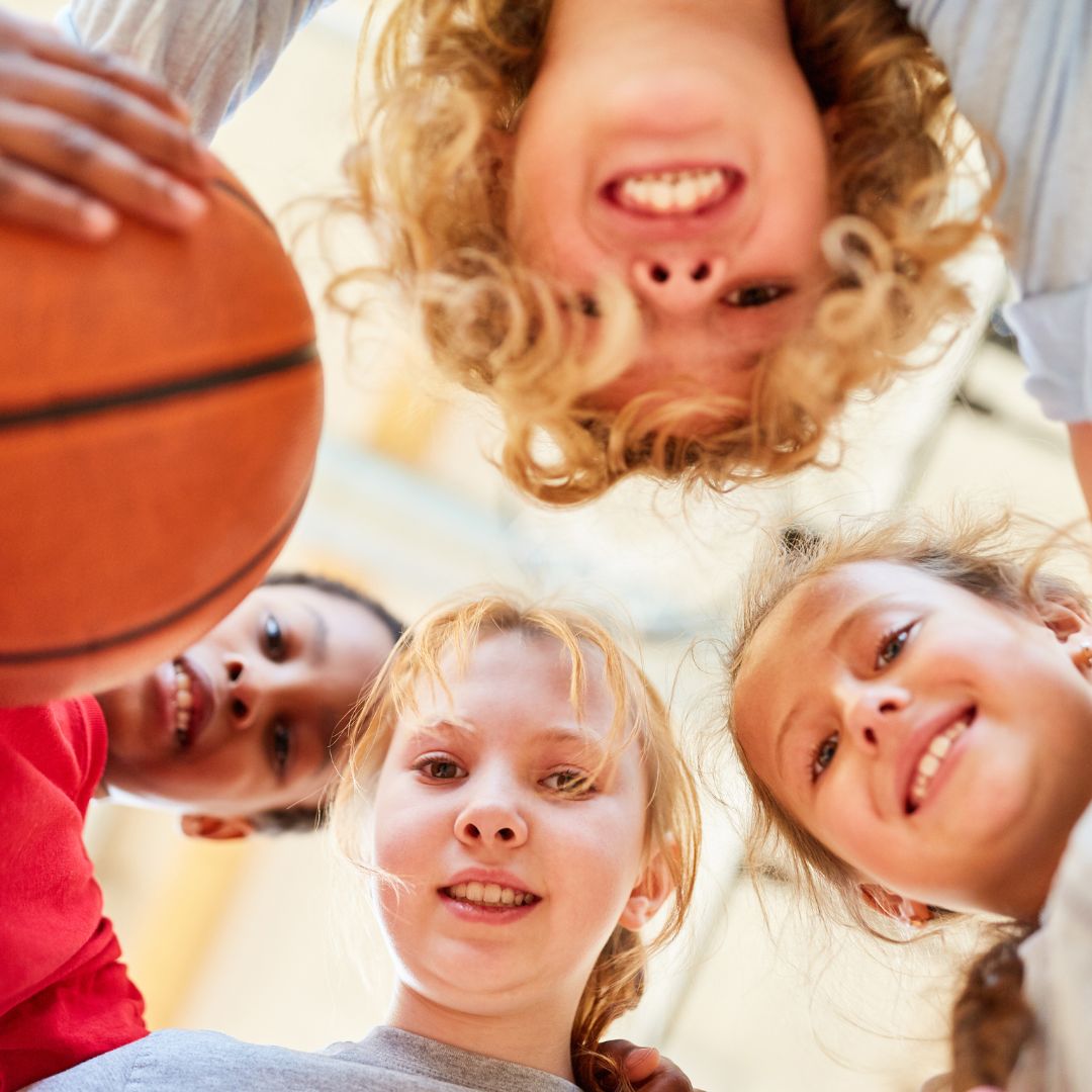 children in basketball huddle